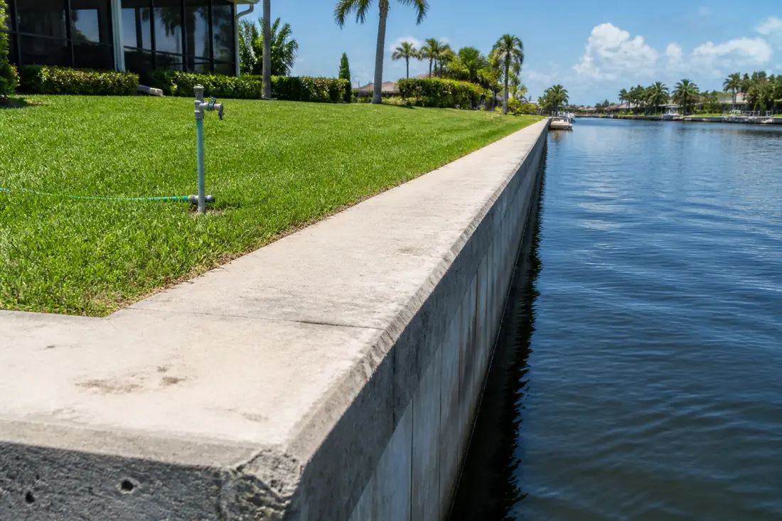 A seawall cap with the ground surface behind it