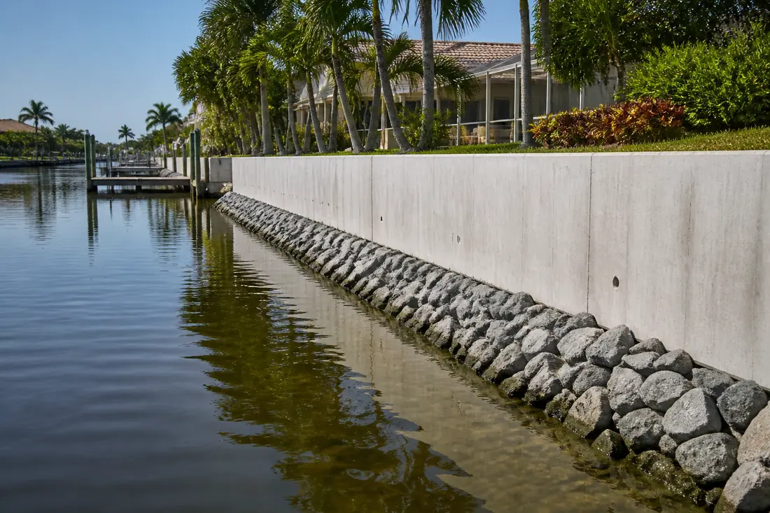 A vertical seawall with rock riprap placed along its toe