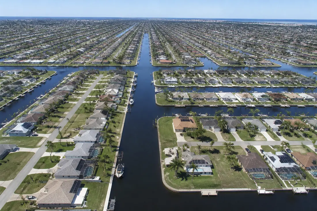 Aerial view of the Cape Coral canal network running between residential streets